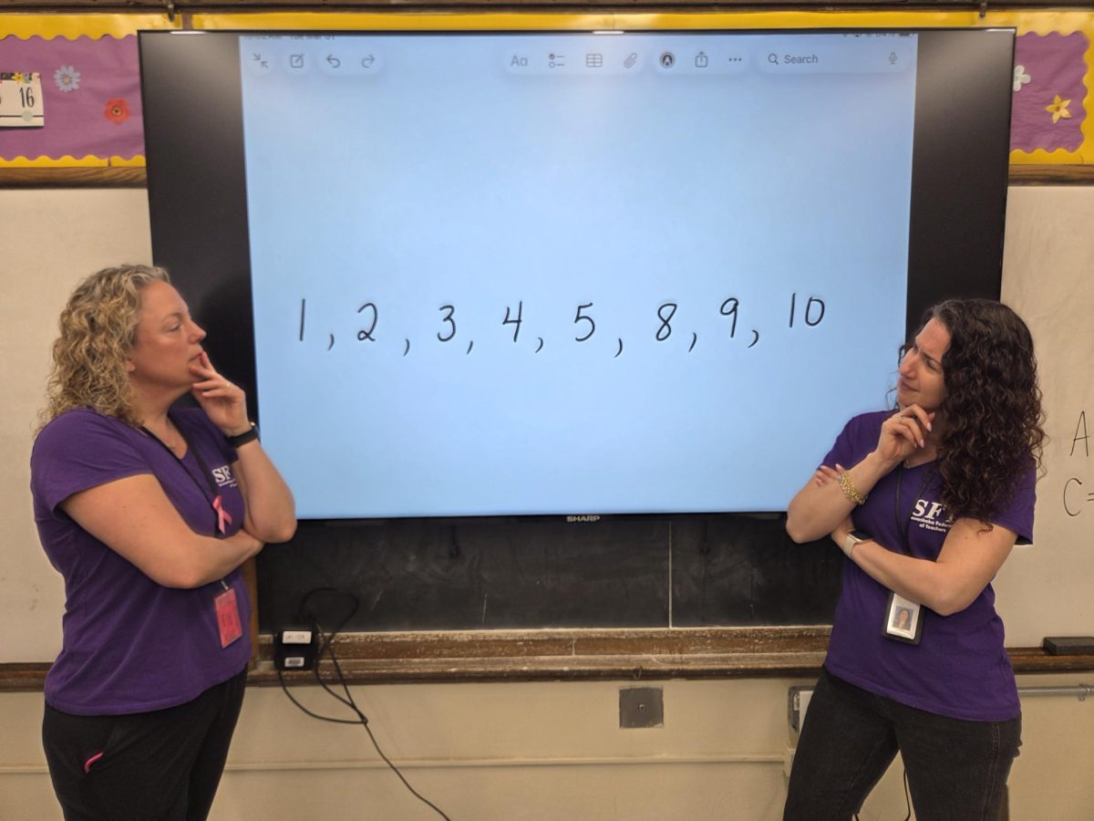 Ms. McGrath and Ms. Rampulla in their 7th grade class.